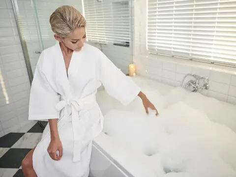Guest beside the private whirlpool bathtub