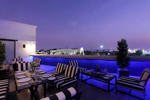 Villa De Khaosan rooftop dining terrace at twilight